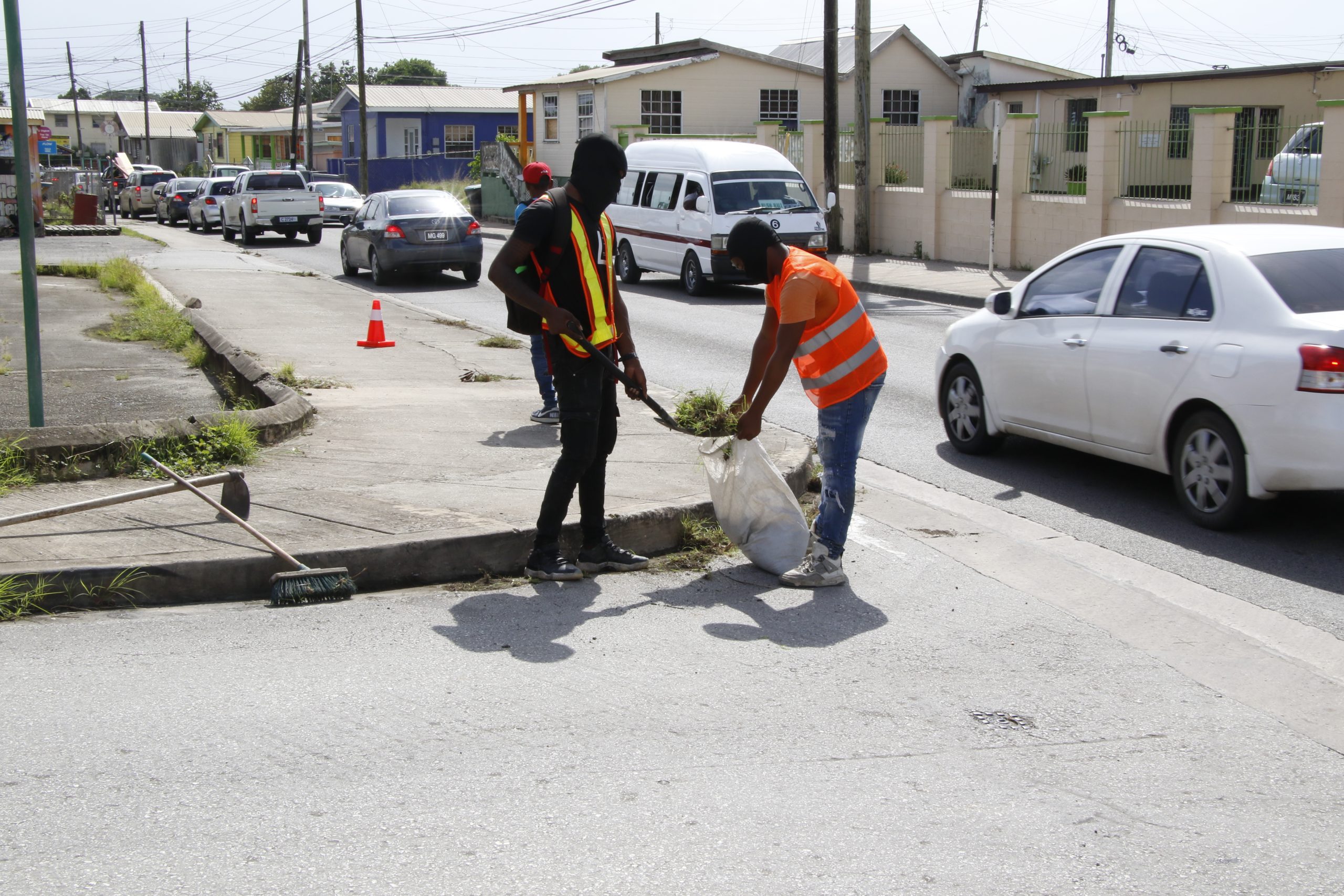 Workers under the Highway Beautification Project weeding along Station Hill, St Michael